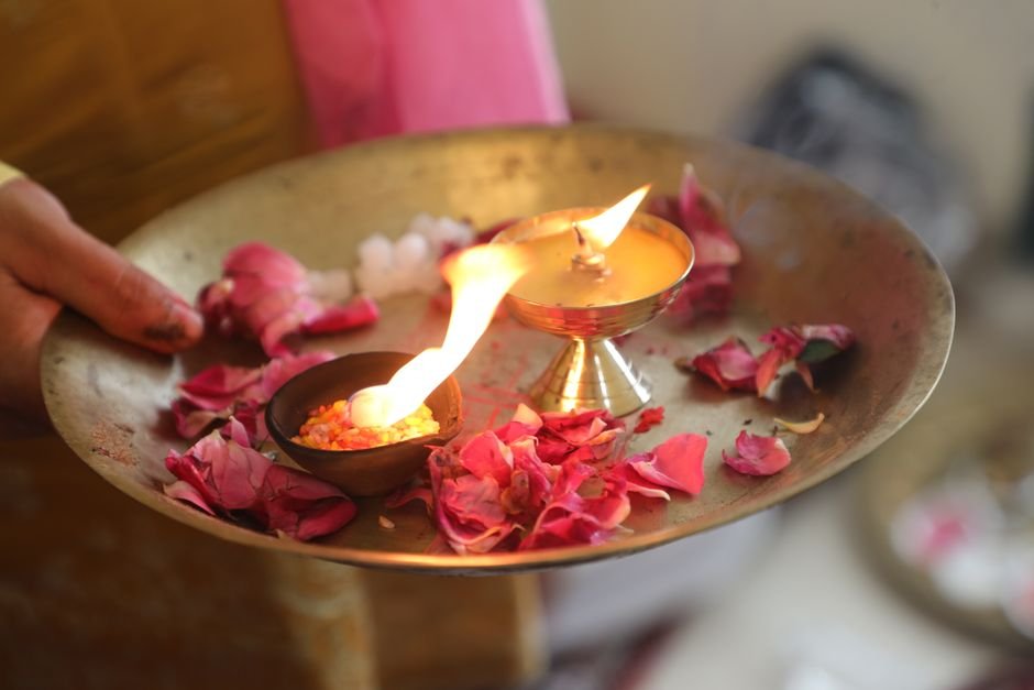 Roses and a candle, illustrating the prayer to Our Lady of Guadalupe